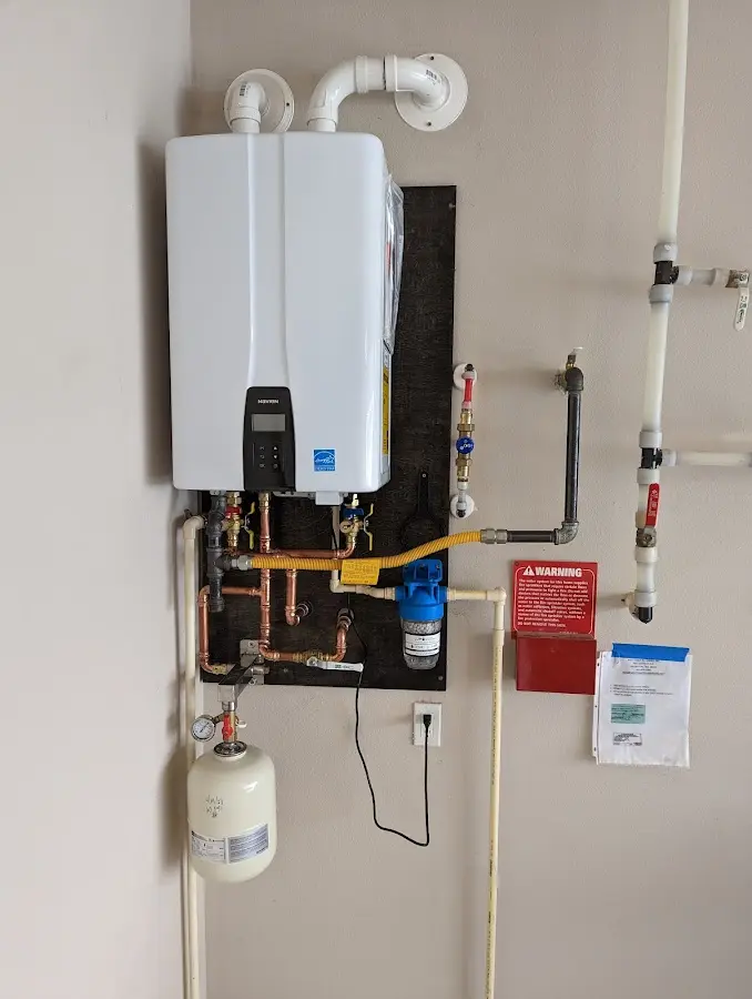 Professional plumber installing copper piping in a Waterloo home